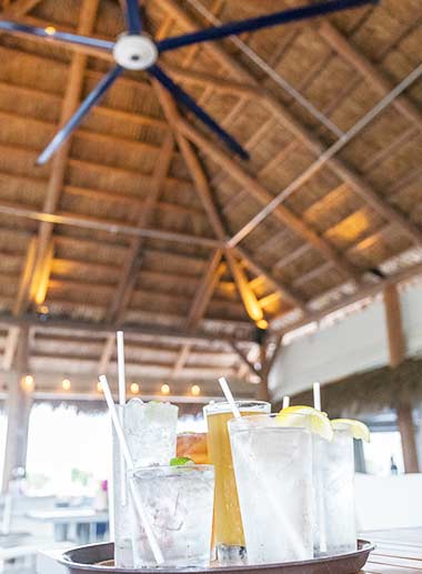 HVLS fan above drinks in an outdoor environment.