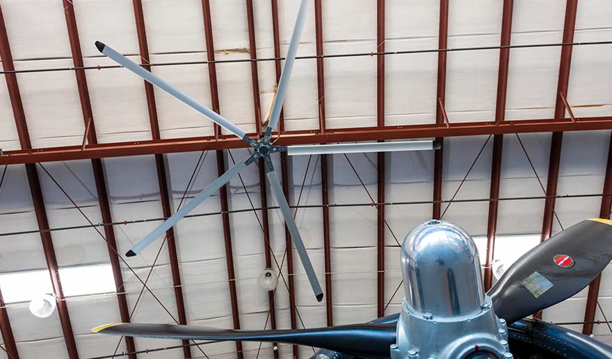 Industrial ceiling fan in aircraft hangar.